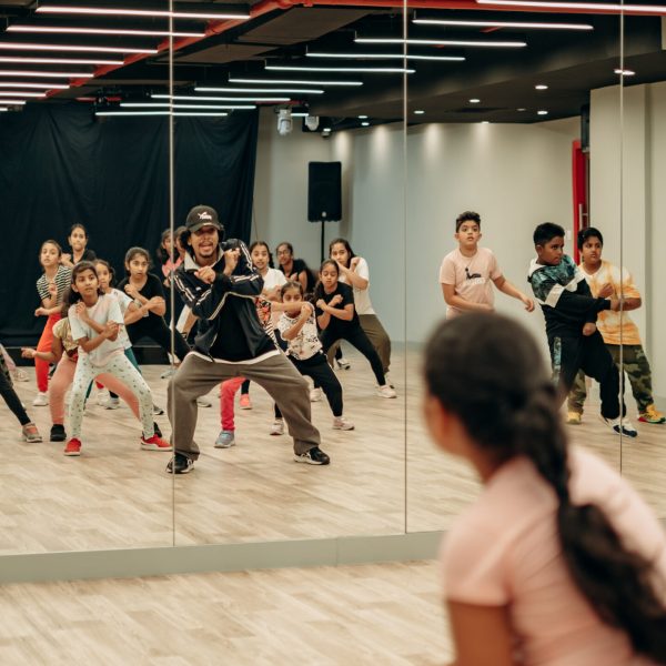 Dance instructor and students practicing routine together in the Dee Studio studio room